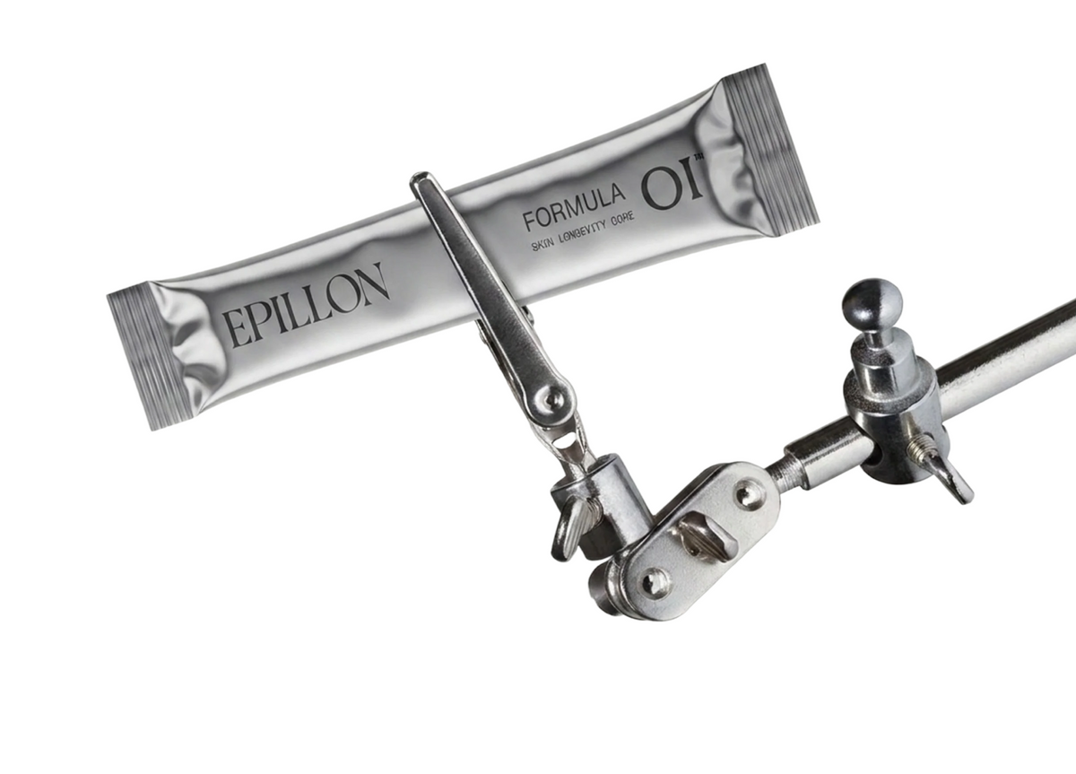 Two Formula 01 sachets held in a polished laboratory clamp stand
